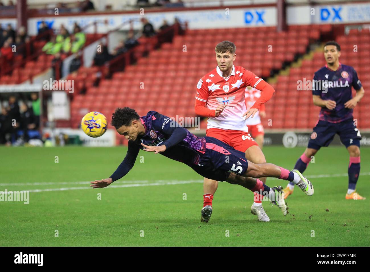 Terence Vancooten #15 of Stevenage heads the ball clear of his own goal during the Sky Bet League 1 match Barnsley vs Stevenage at Oakwell, Barnsley, United Kingdom, 23rd December 2023  (Photo by Alfie Cosgrove/News Images) Stock Photo