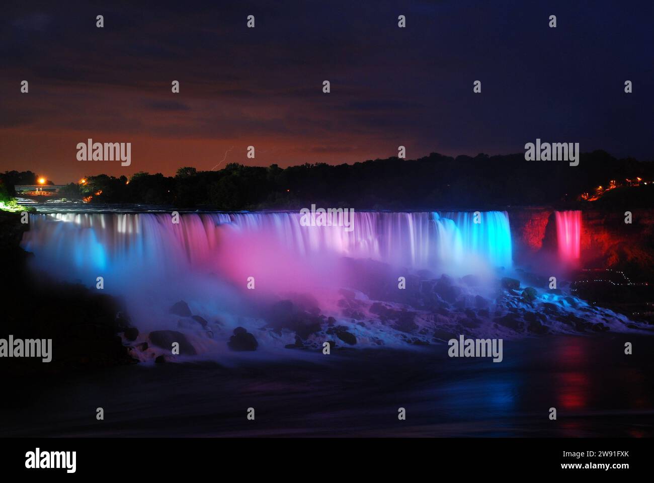 Colorful lights illuminate the American Falls from the Canadian side at