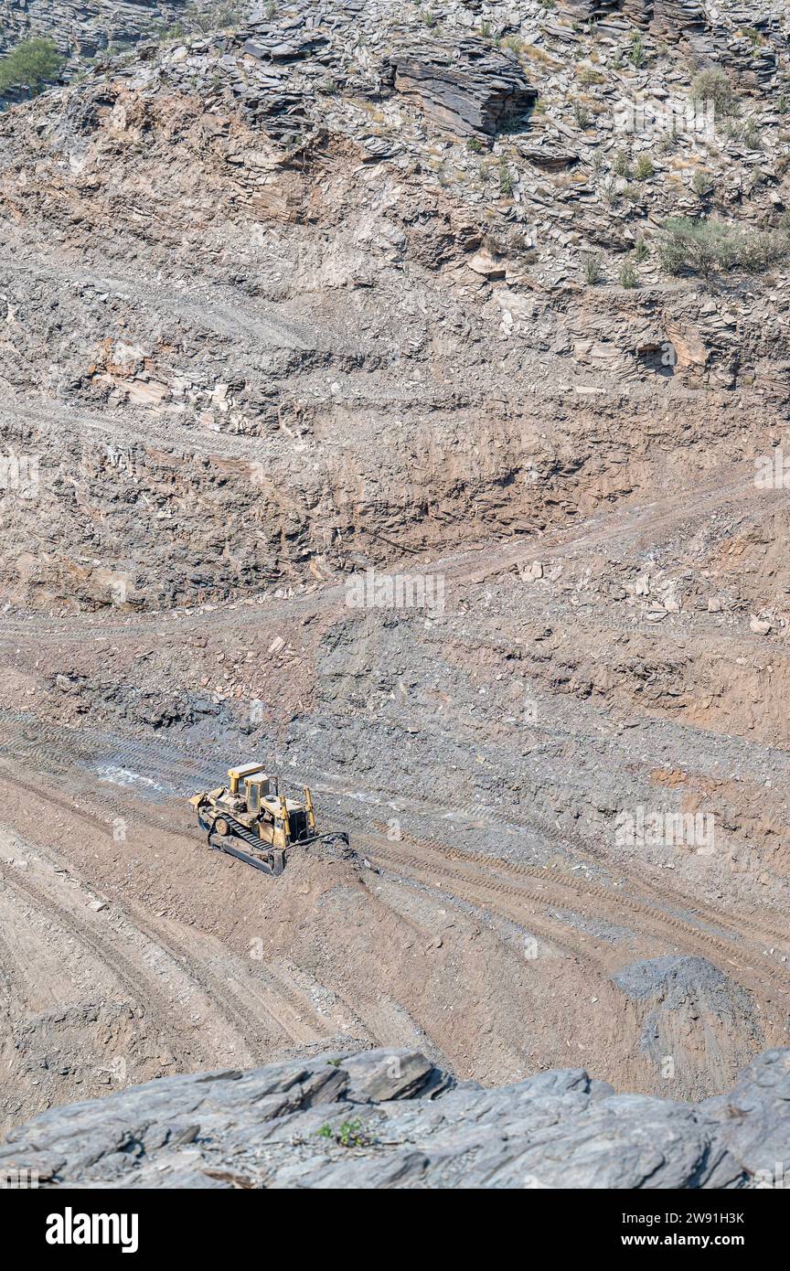 Heavy machinery in the process of mountain road construction works in Saudi Arabia Stock Photo