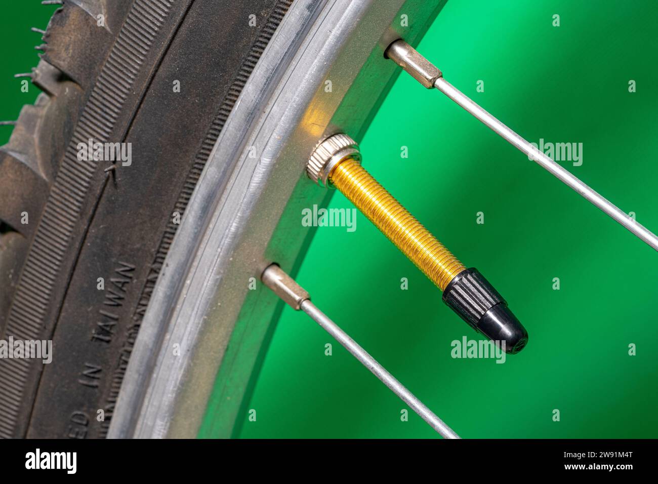 Presta valve with bicycle tire cap on green background Stock Photo Alamy