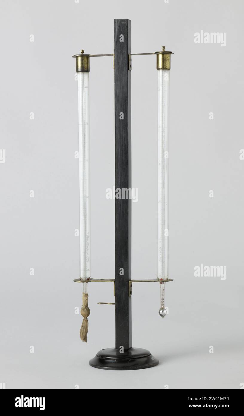 Psychrometer, H. Geissler, 1846  Humidity meter of the psychrometer type, with two thermometers in a standard, incomplete. The scale of both thermometers goes from -12 ° to +44 ° Celsius. One thermometer has a sock around the mercury ball, which is made moist. From the temperature difference between the two thermometers caused by the evaporation of the moisture, the humidity of the air can be read. The foot of De Standaard is weighted with lead. instrument maker: The Hagueafter design by: Berlin wood (plant material). brass (alloy). lead (metal). glass. mercury. wax. textile materials Stock Photo