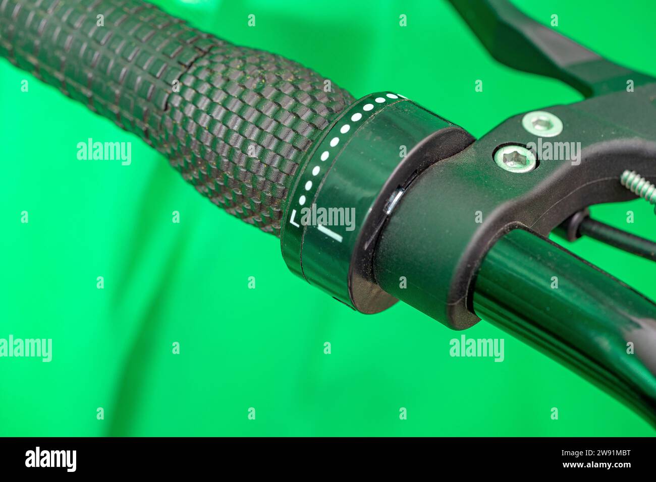gear lever on bicycle handlebar grip under green background Stock Photo