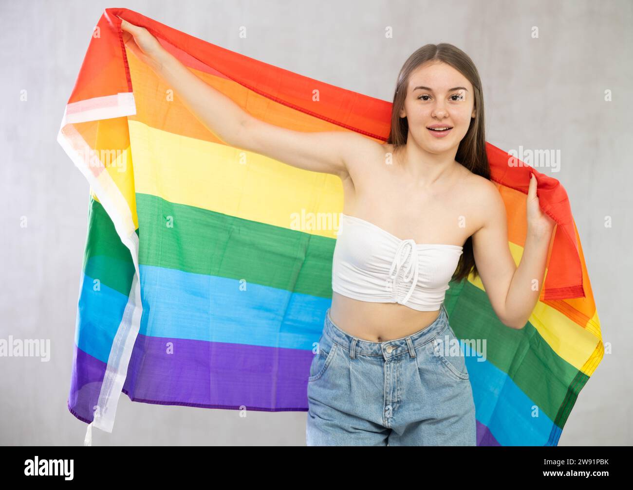 Portrait of a playful girl holding an LGBT flag in hands Stock Photo ...