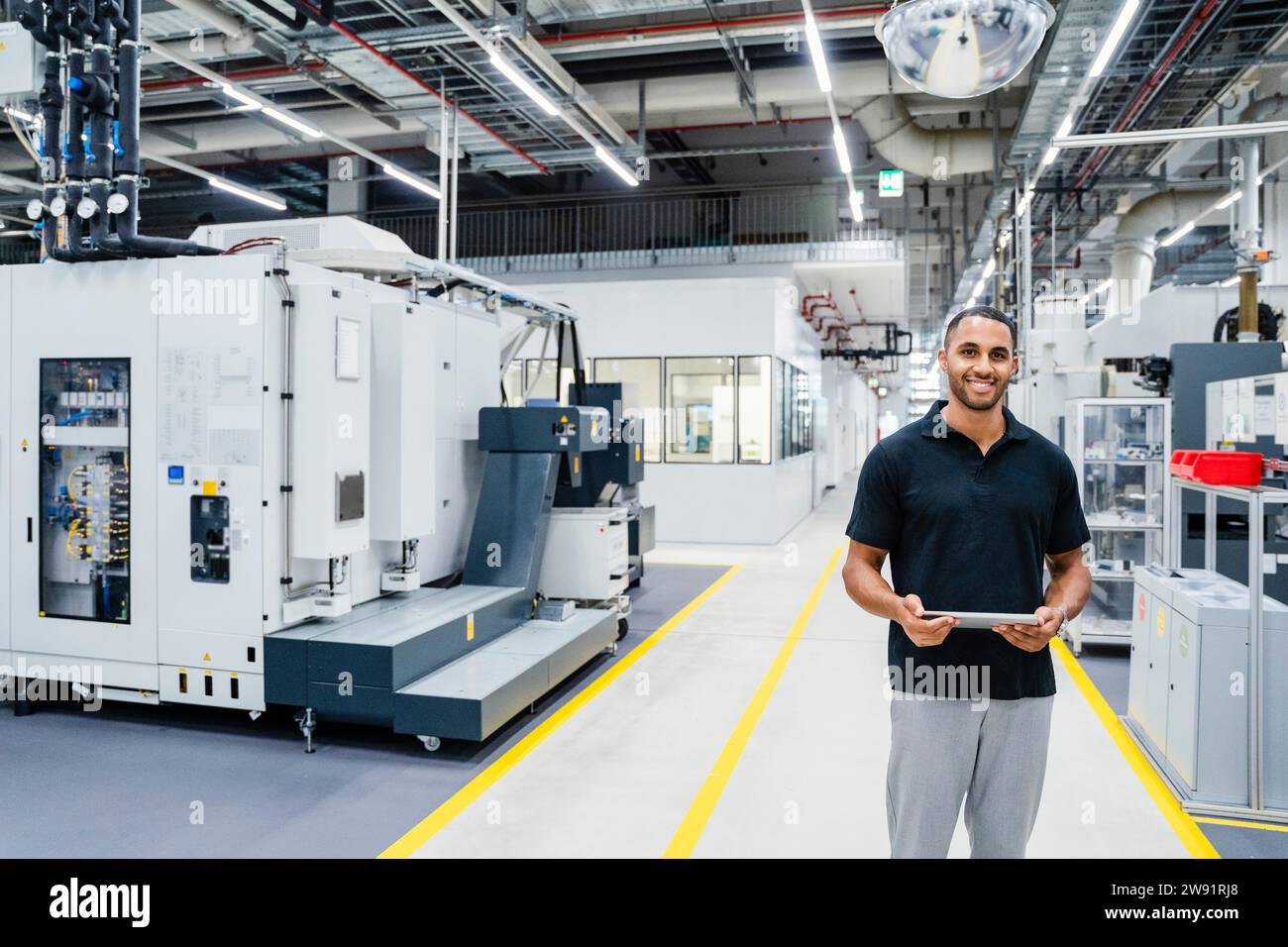 Technician using digital tablet on shop floor in a factory Stock Photo ...