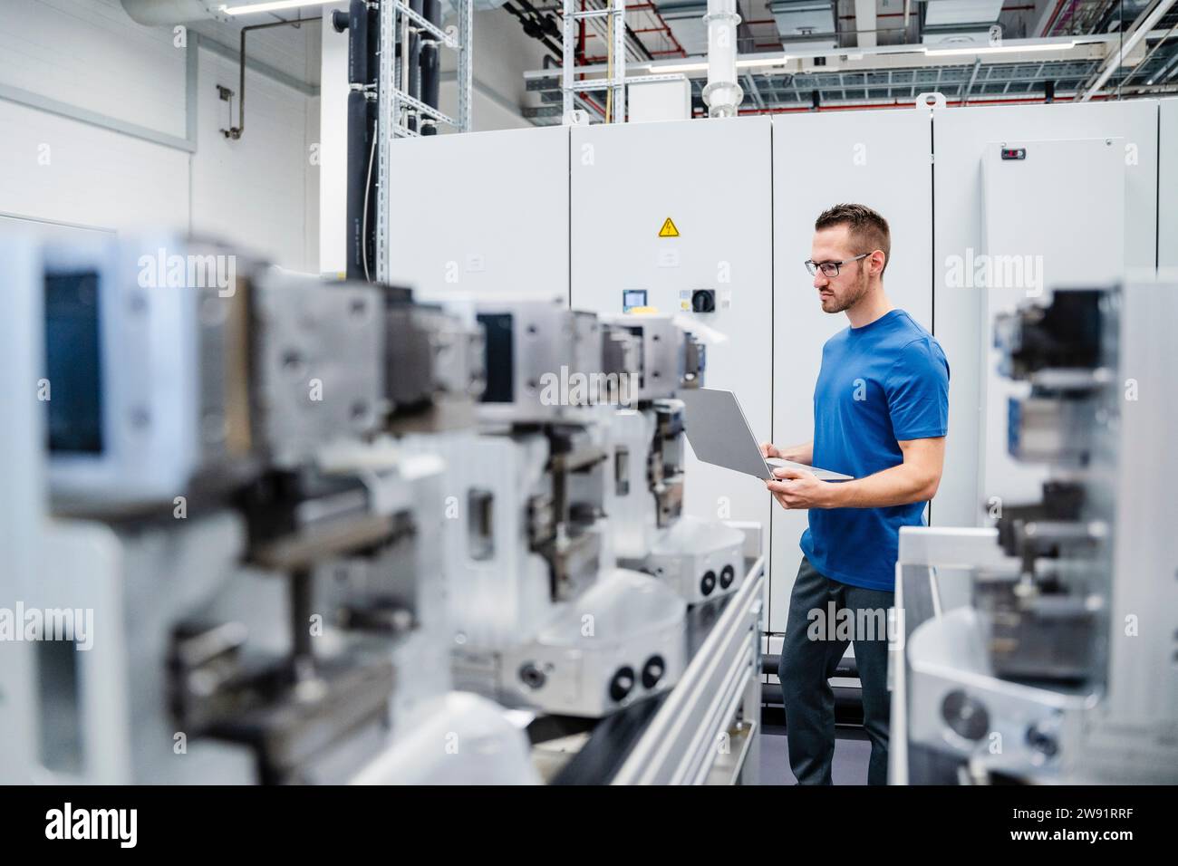 Technician using digital tablet on shop floor in a factory Stock Photo ...