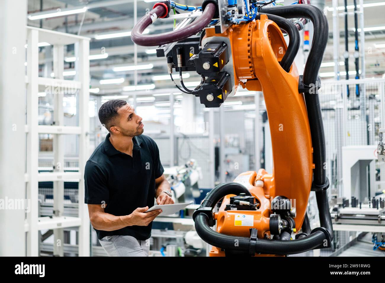 Technician examining industrial robot in a factory Stock Photo Alamy