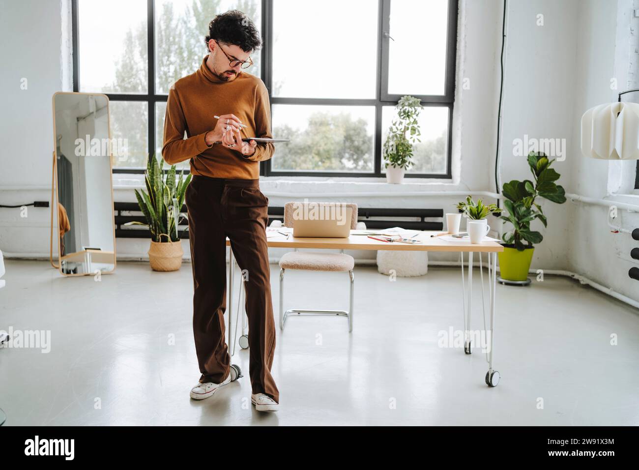 Graphic designer working near desk at office Stock Photo