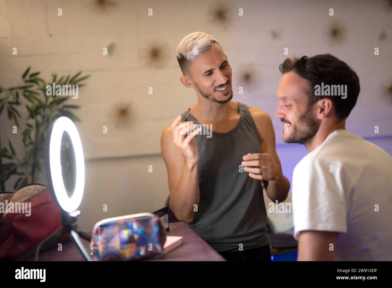 Beautician doing makeup of customer at salon Stock Photo