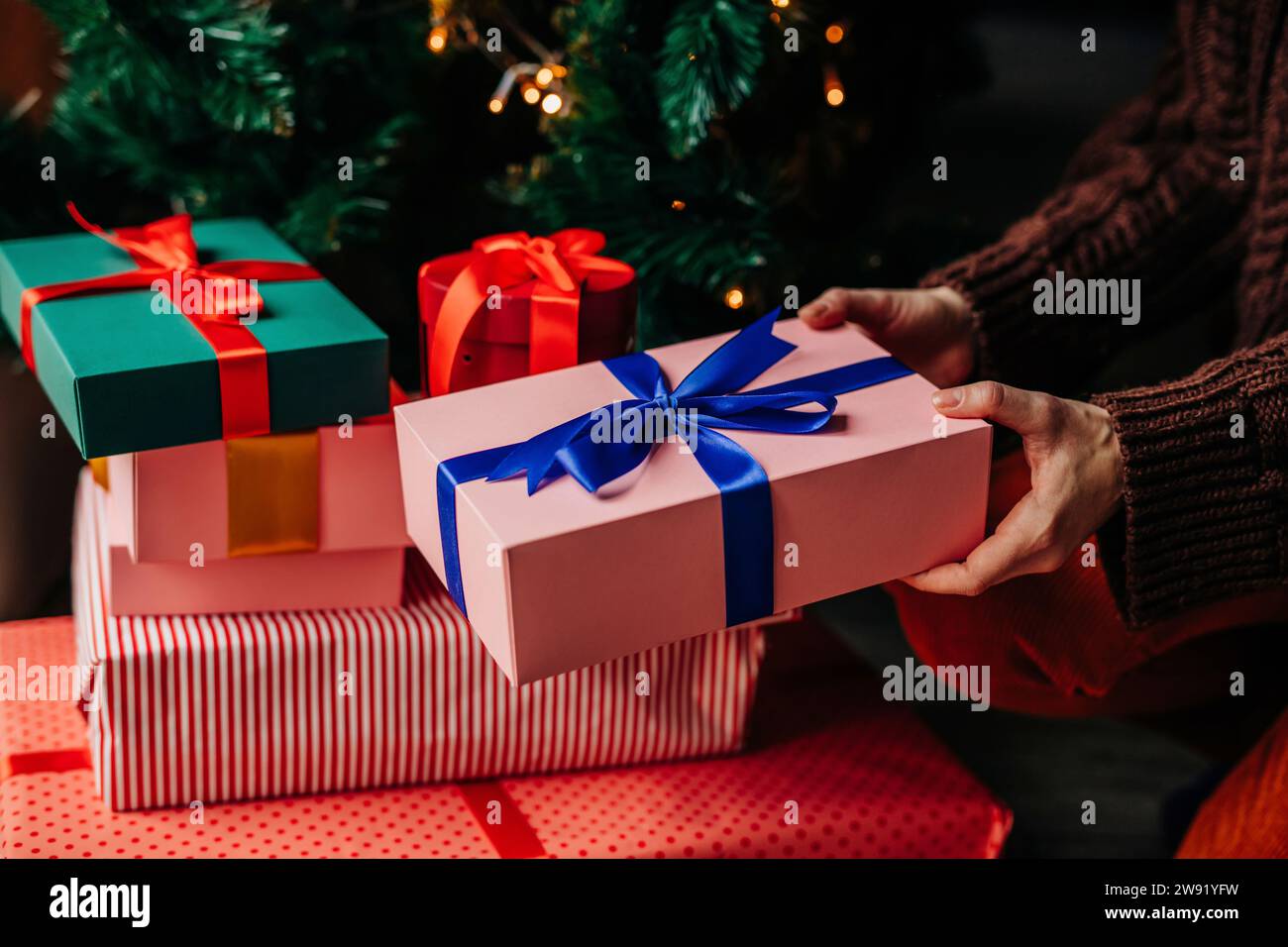 Hands woman stacking gifts hi-res stock photography and images - Alamy
