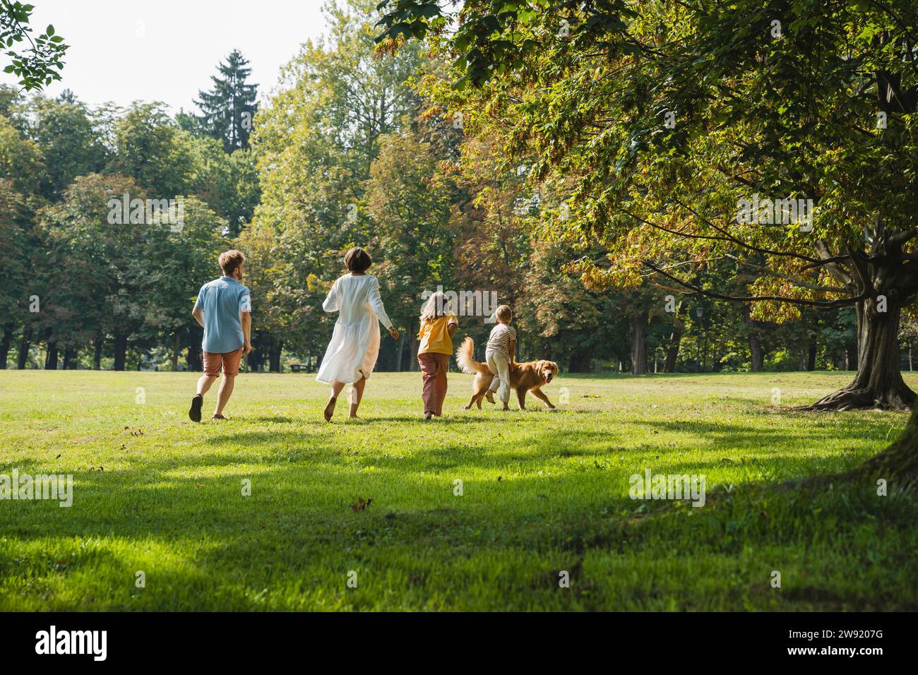 Family running with dog hi-res stock photography and images - Alamy