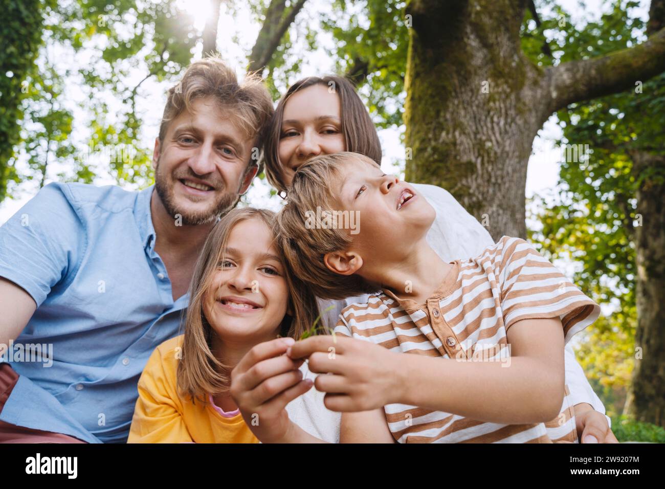 Happy parents with son and daughter at park Stock Photo