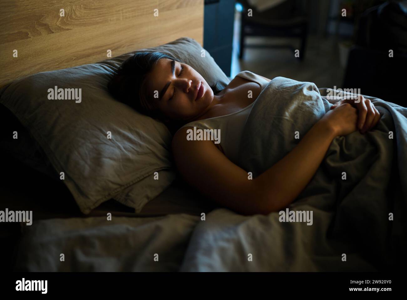 Young woman sleeping on bed at home Stock Photo