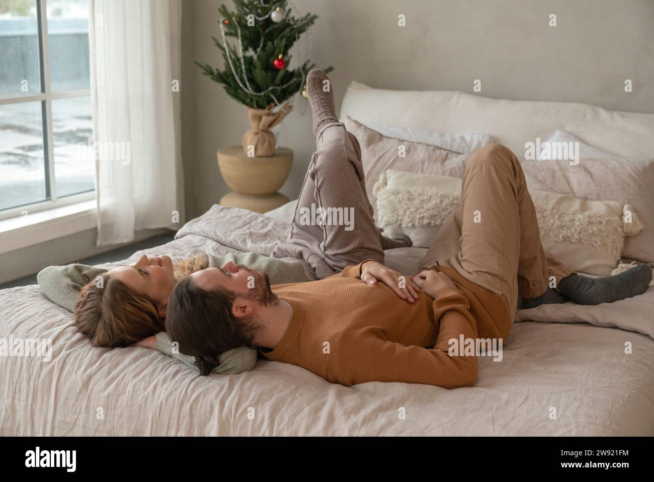 Couple lying together on bed hi-res stock photography and images - Alamy