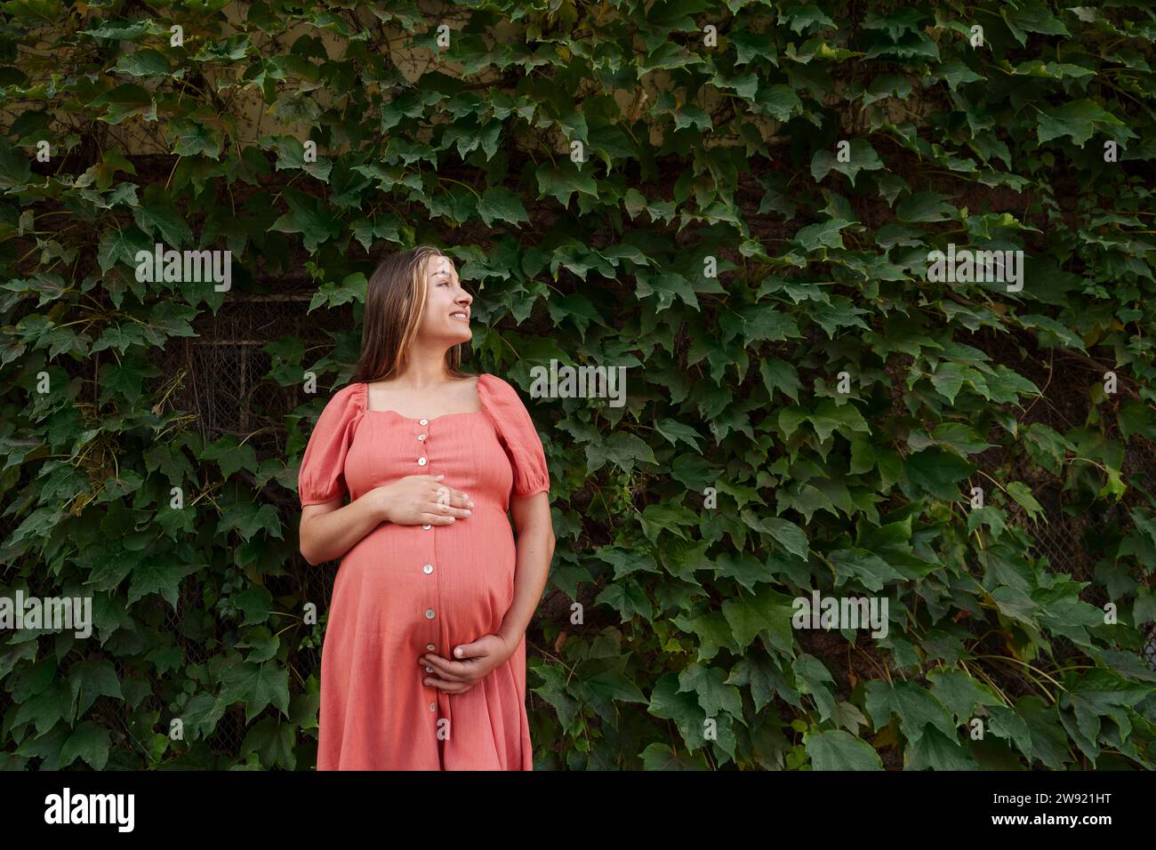 Pregnant woman wearing red dress hi-res stock photography and images ...