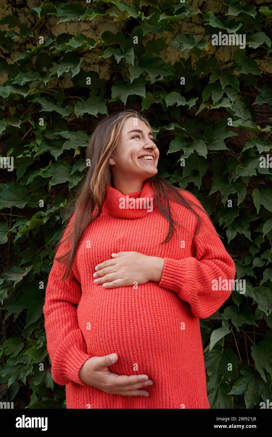 Pregnant woman in red dress hi-res stock photography and images - Alamy