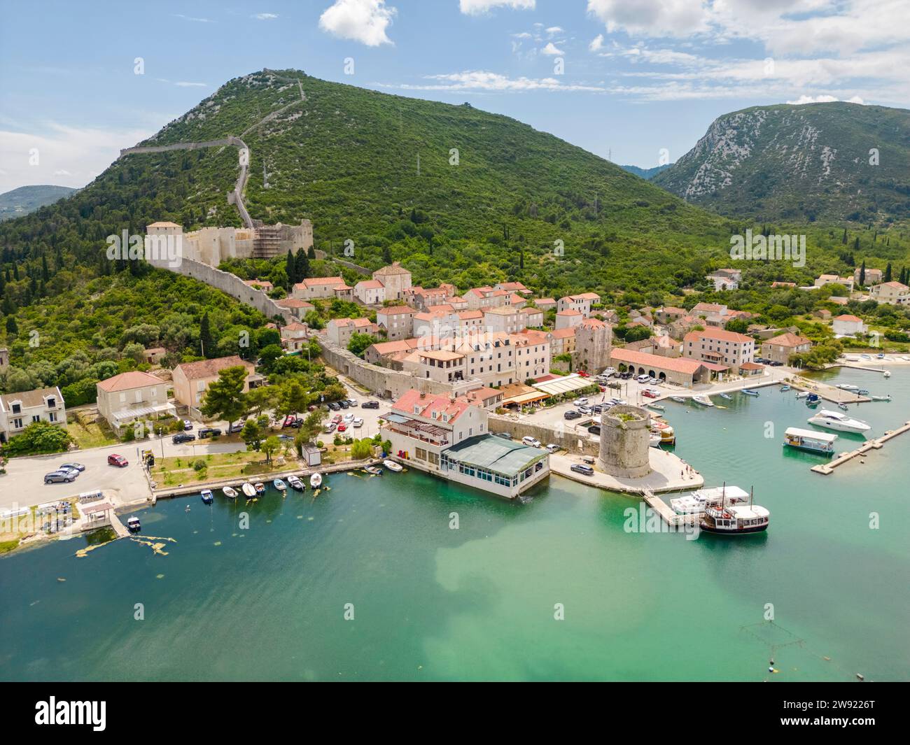 Croatia, Dubrovnik-Neretva County, Mali Stron, Aerial view of coastal village and surrounding mountains in summer Stock Photo