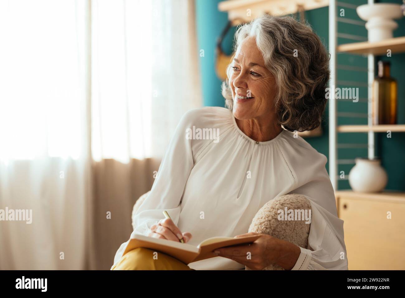 Smiling psychologist conducting consultation at home Stock Photo