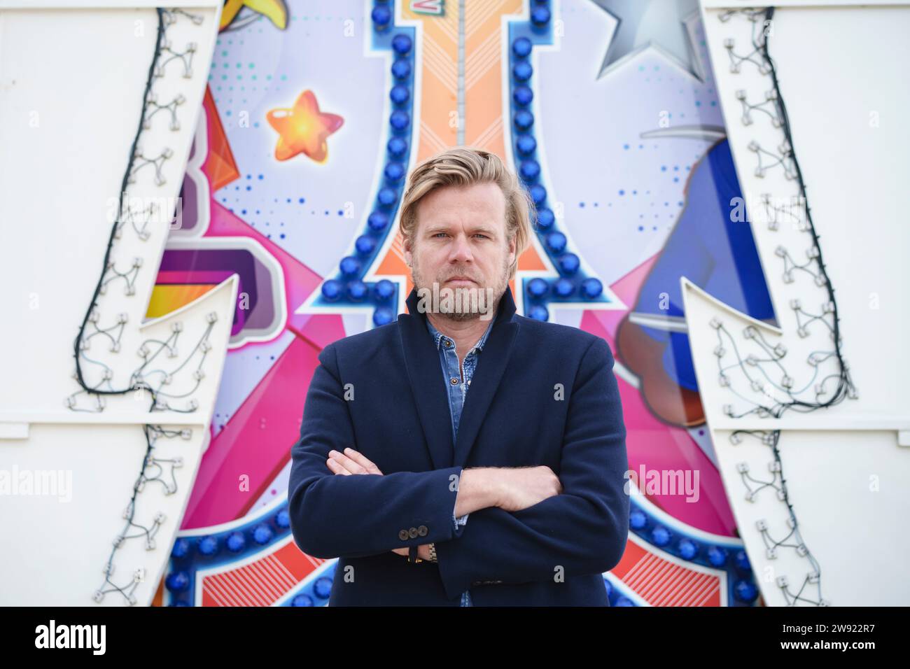 Businessman with arms crossed standing in front of wall art Stock Photo ...