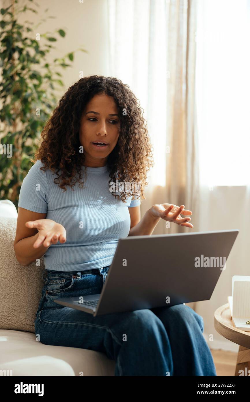 Therapist consulting on video call through laptop at home Stock Photo