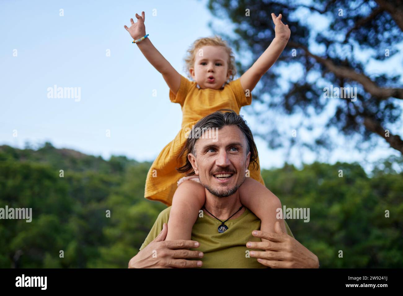 Girl sitting on shoulders hi-res stock photography and images - Alamy