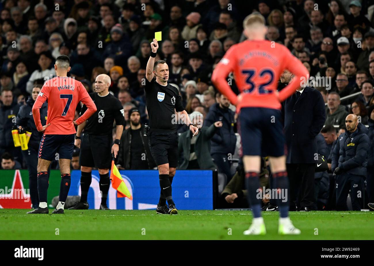 London, UK. 23rd Dec, 2023. Stuart Attwell (Referee) shows the yellow