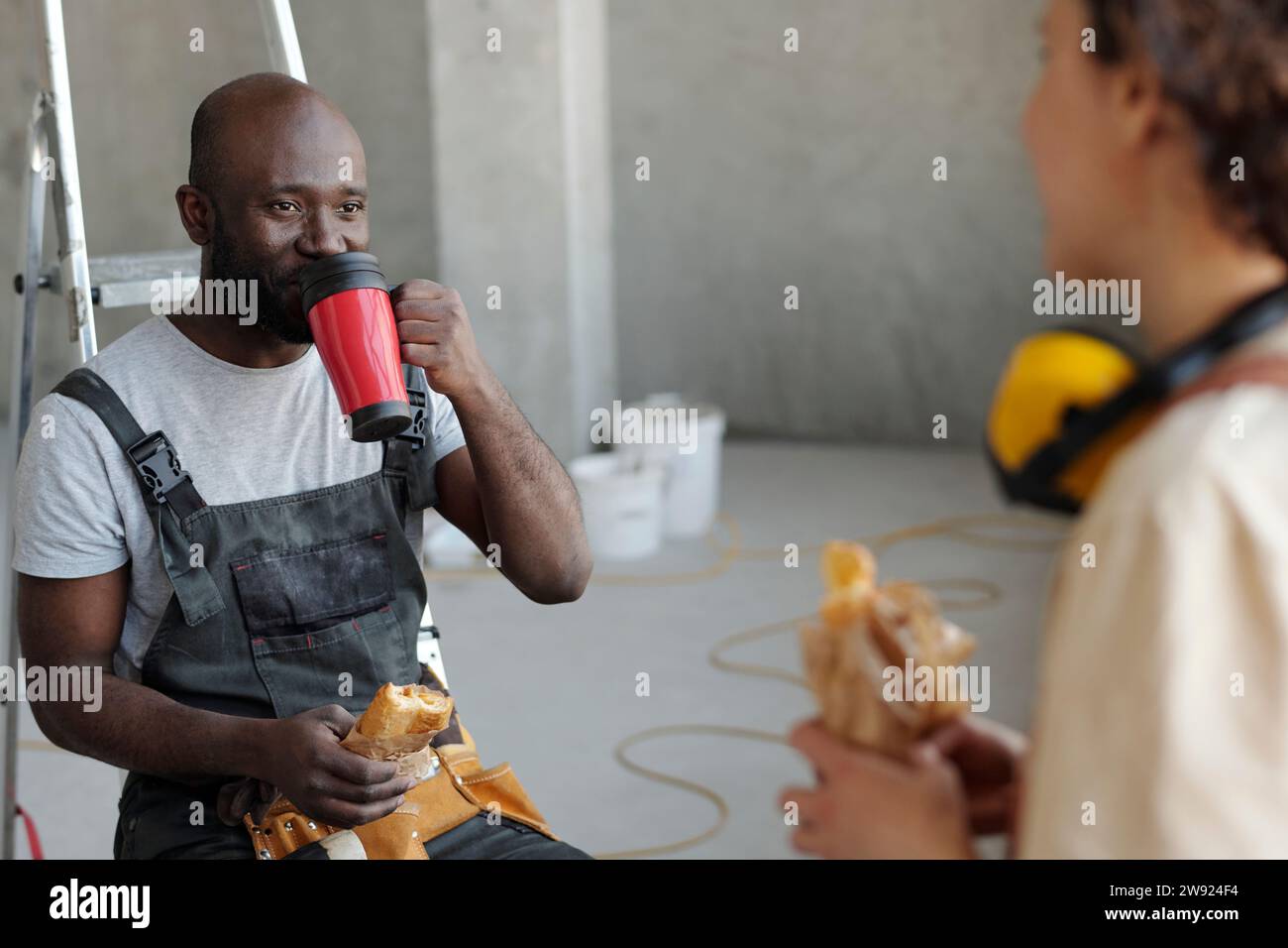 Construction workers taking lunch break at site Stock Photo