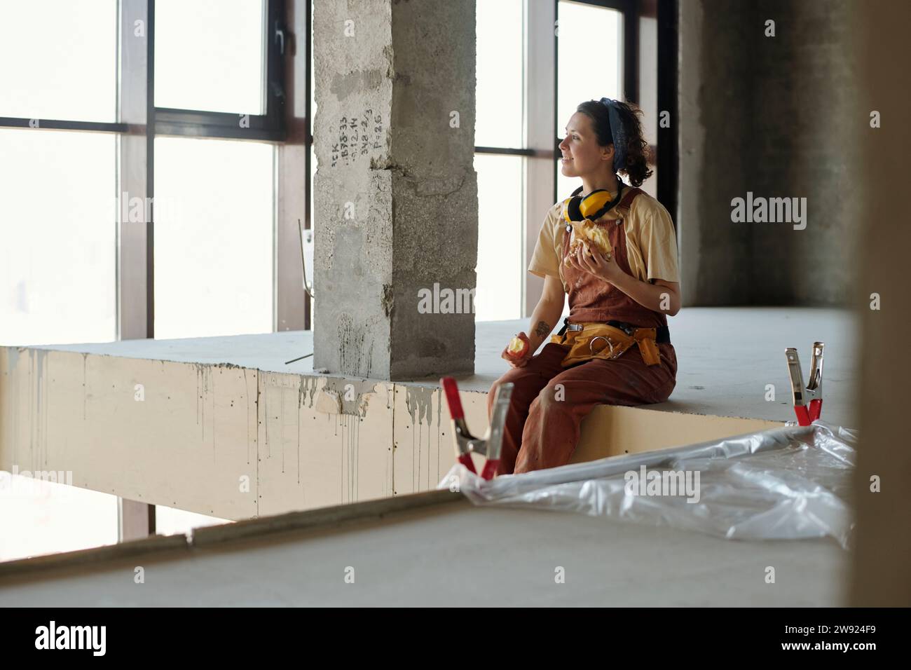 Smiling construction worker having lunch at site Stock Photo