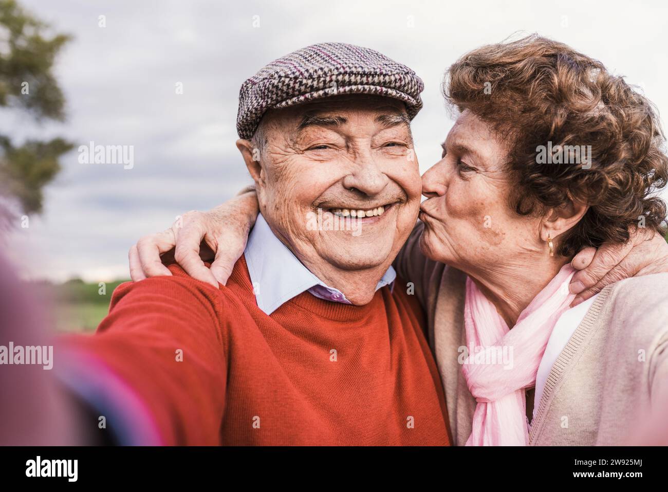 Woman kissing man in cheek hi-res stock photography and images - Alamy