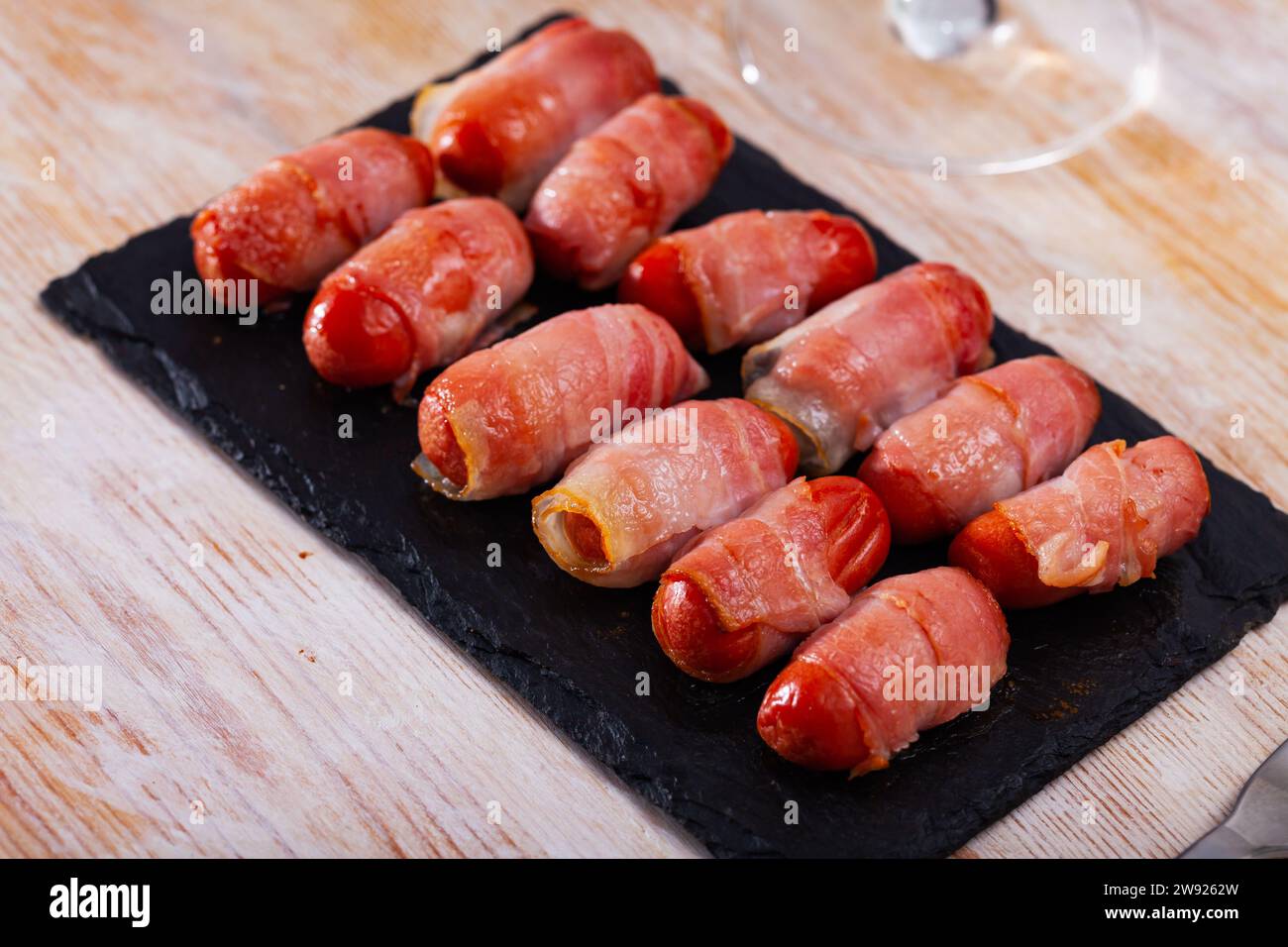 Miniature sausage links wrapped in bacon Stock Photo Alamy
