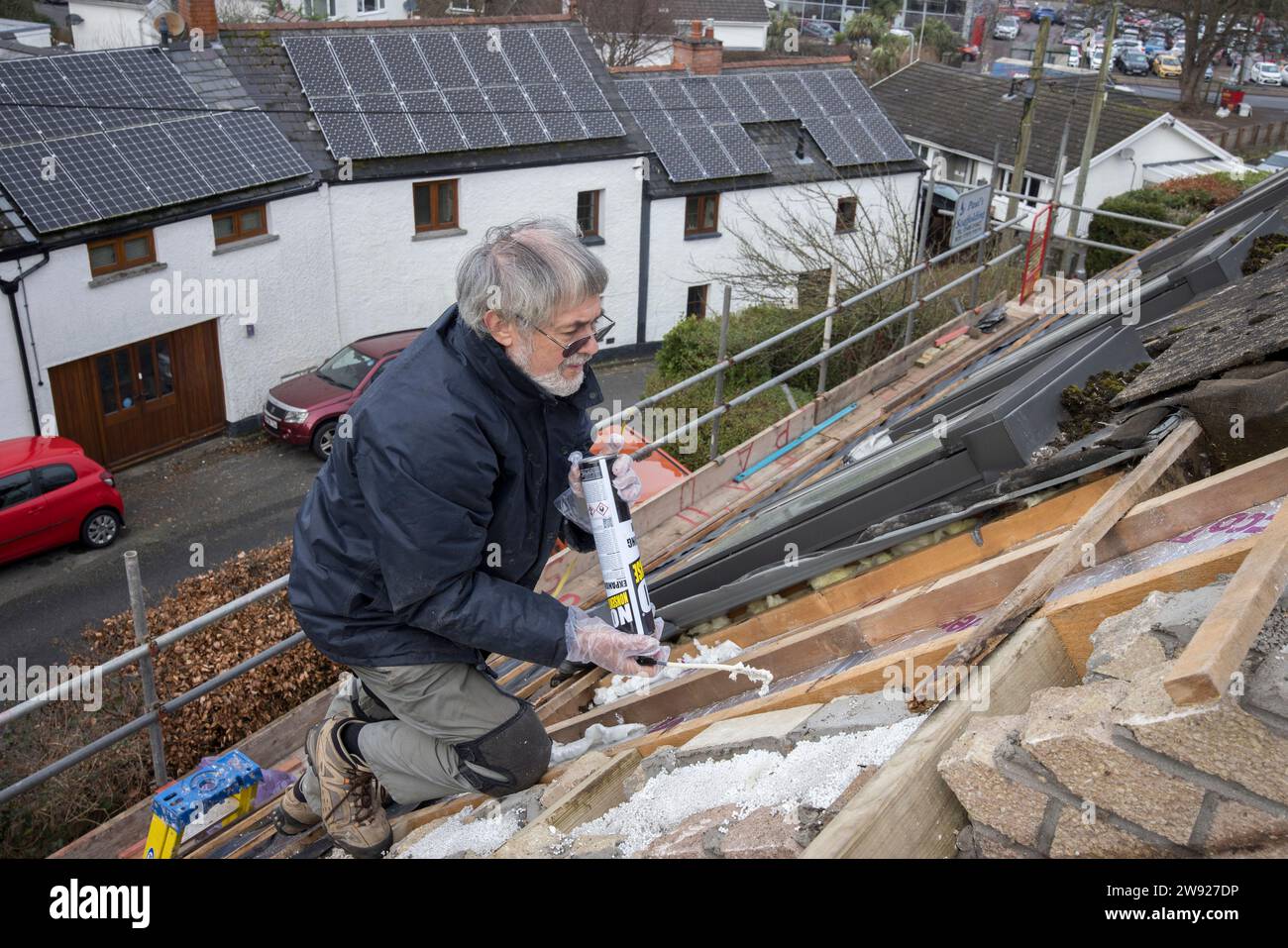 Sealing insulation boards with expanded foam while replacing a roof on