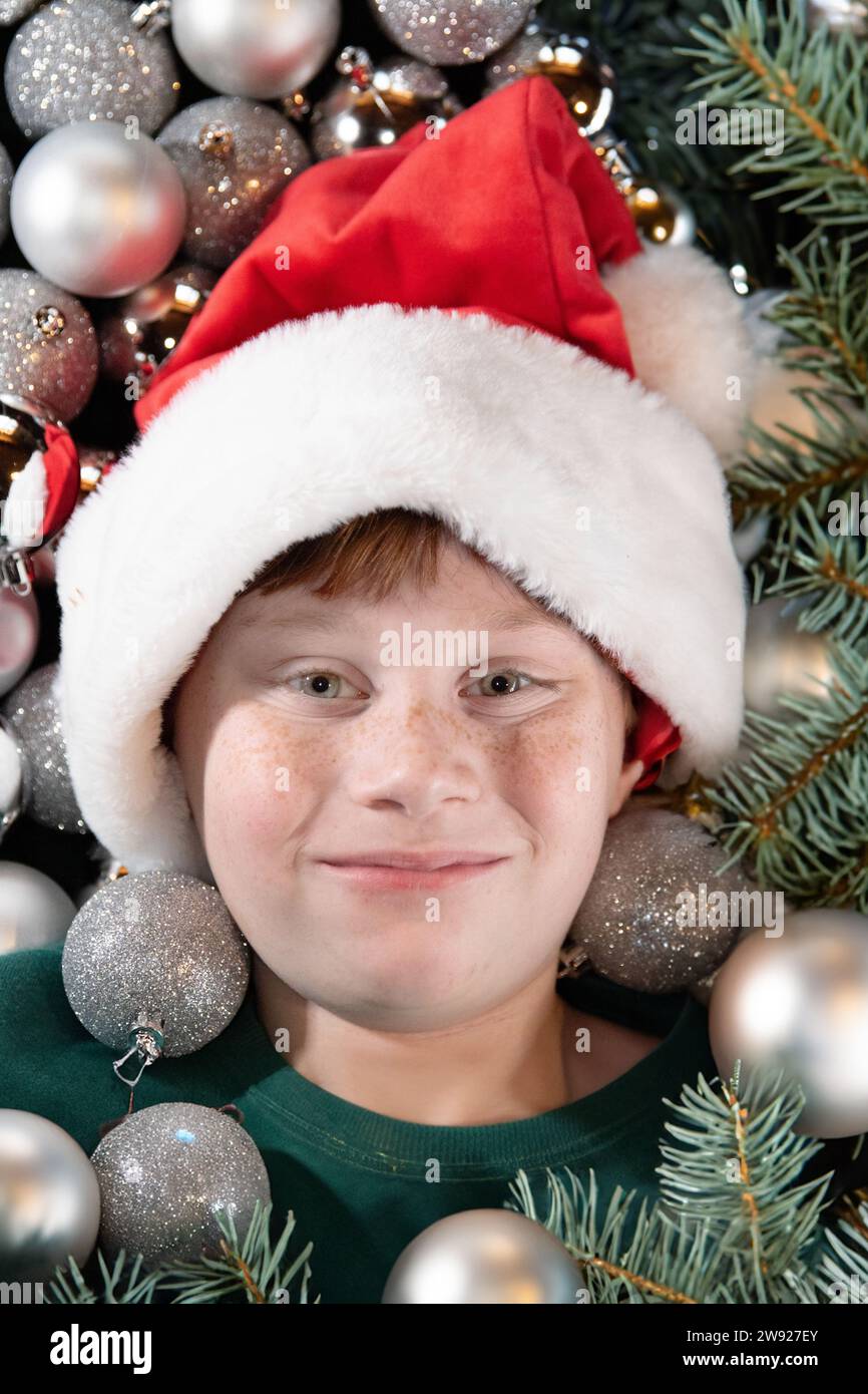 Christmas photo of a boy covered in ornaments Stock Photo