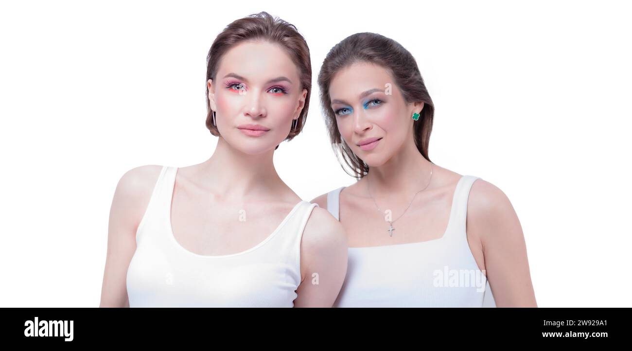 Portrait of two beautiful girls with defiant make-up on a white background. Female friendship concept. High quality Stock Photo
