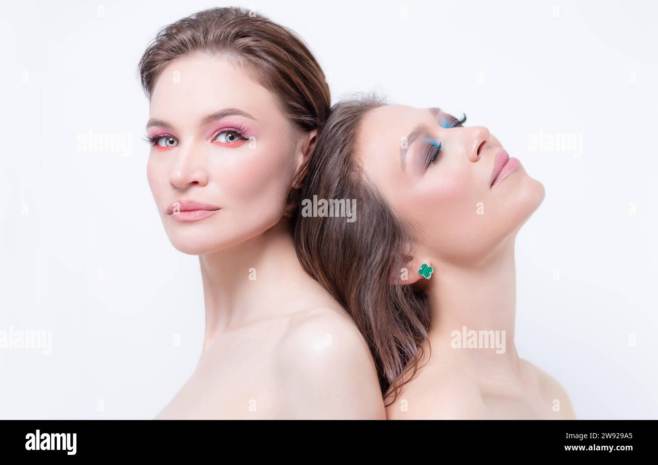 Portrait of two beautiful girls with defiant make-up on a white background. Female friendship concept. High quality Stock Photo