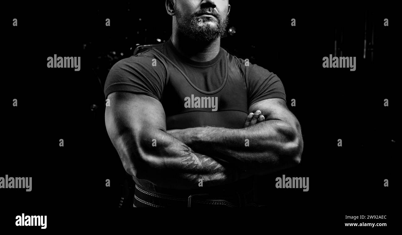 Huge powerlifter stands in front of the camera and strains his huge hands. Mixed media Stock Photo