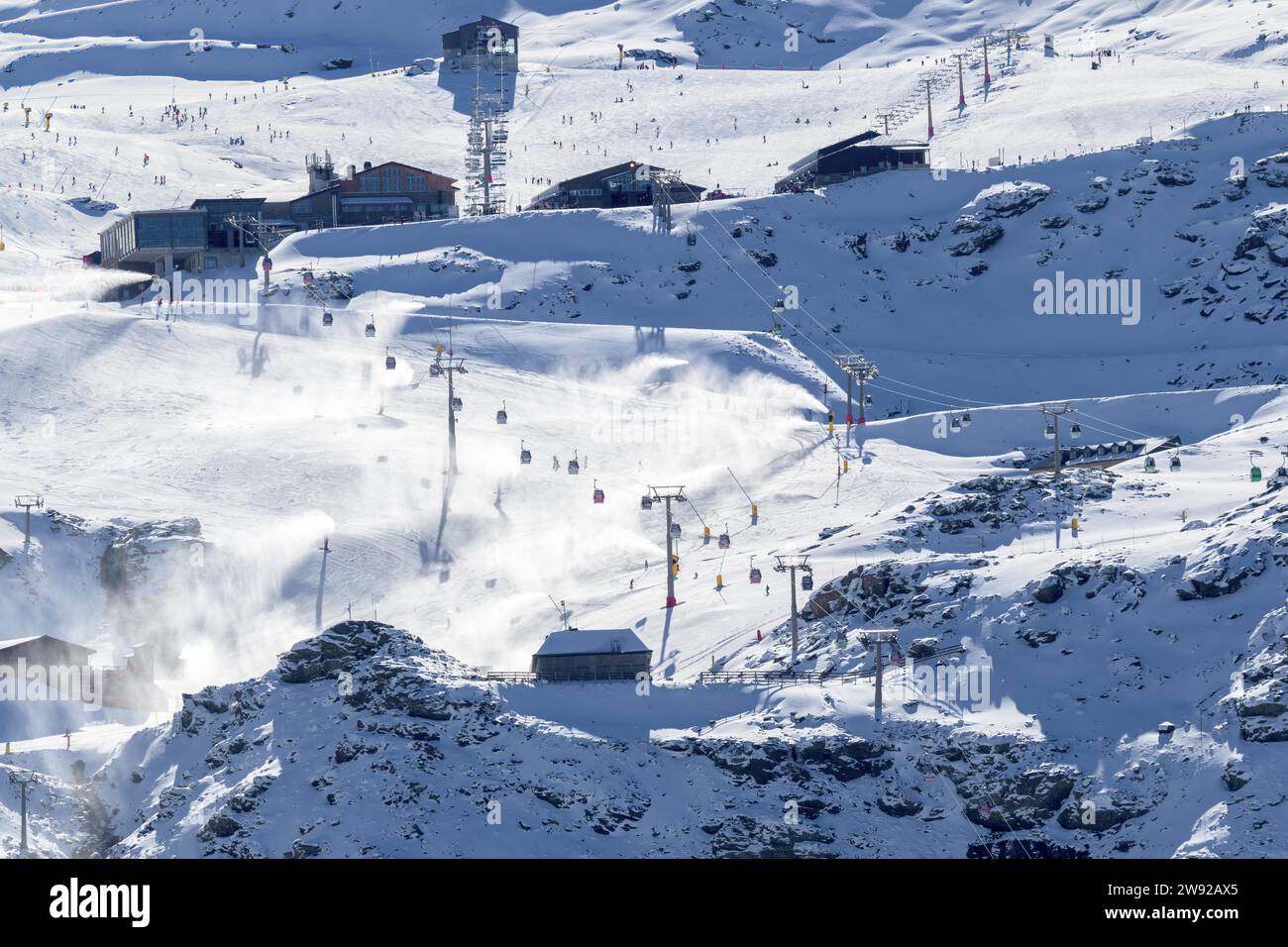 Snow-covered ski resort with active ski lifts in a mountainous alpine region Stock Photo