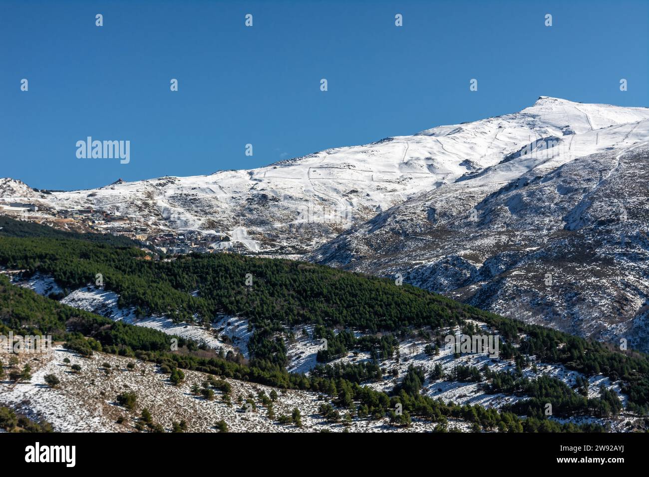 Panoramic view of ski resort in sierra nevada, skiers along the slopes Stock Photo