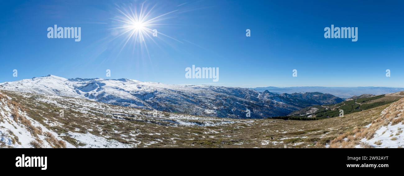 Panoramic view of snow-covered mountains under a clear blue sky with ...