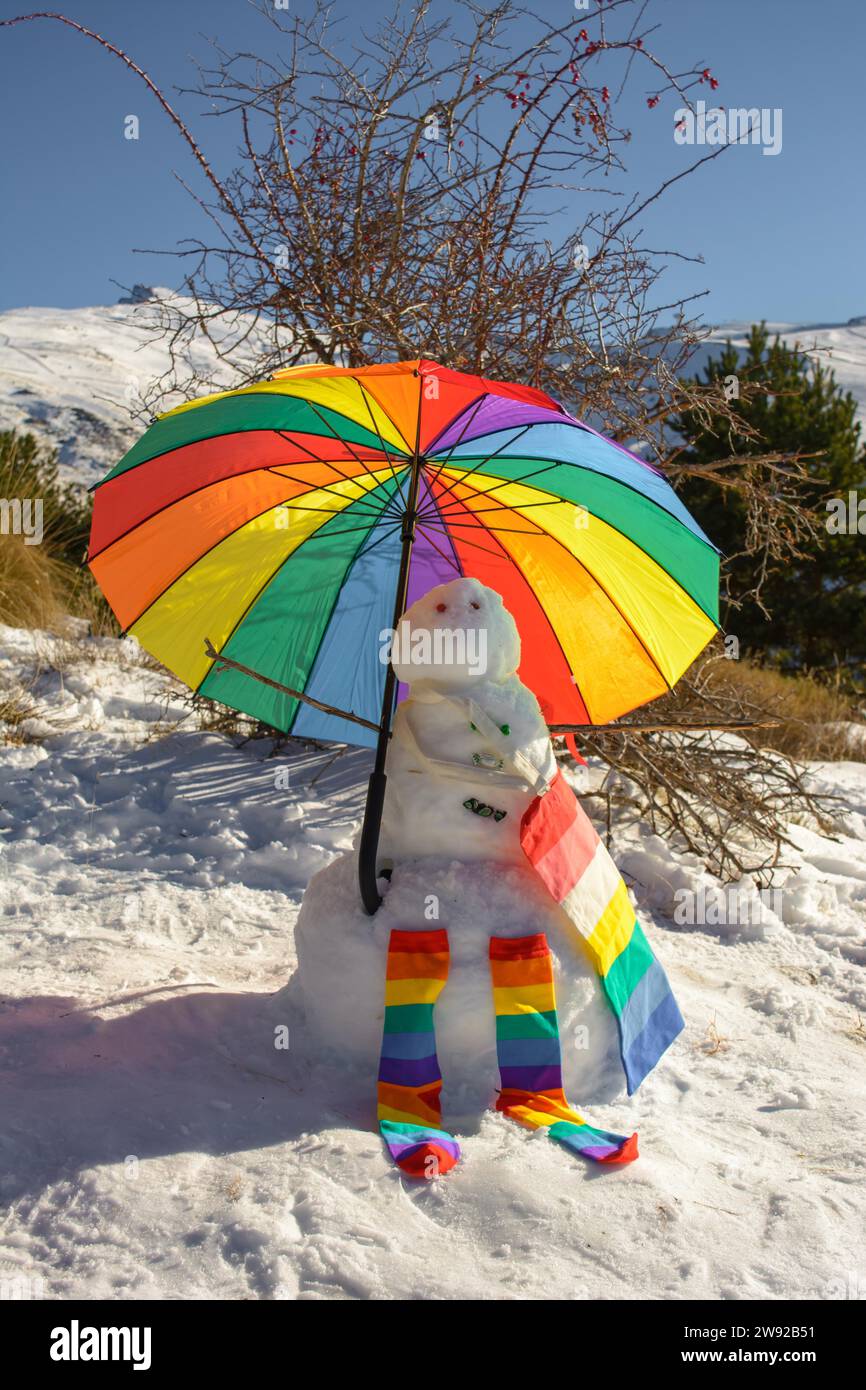 Snowman decorated with umbrella, socks and bag, rainbow colors, pride, lgtb concept Stock Photo