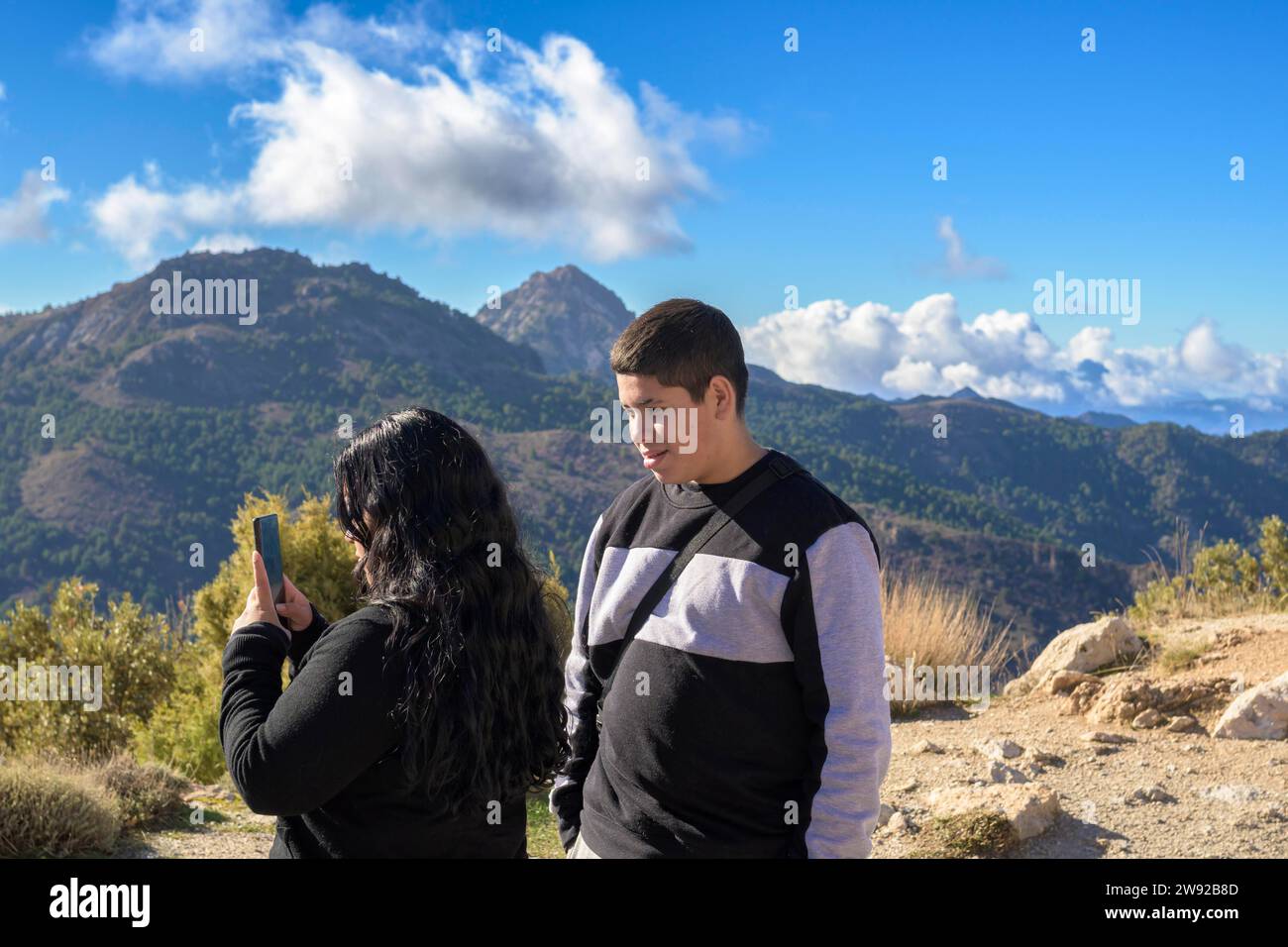 Latin guys, taking smart phone pictures of the mountains in sierra nevada, granada, spain Stock Photo