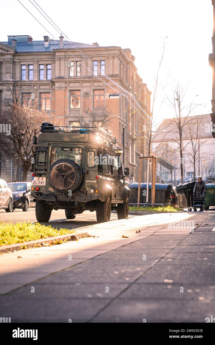 An off-road vehicle parked on a city street during a sunny autumn evening, Stuttgart, Germany Stock Photo