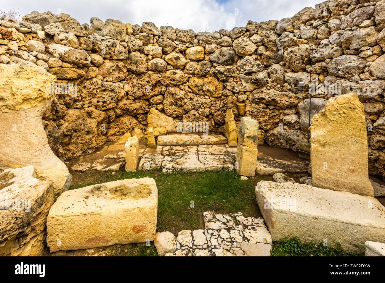 The remains of an altar can still be seen in an apse of the southern Ġgantija temple. Soft limestone, which was easier to work with the stone tools available at the time, was used inside the temples. The temple is part of the UNESCO World Heritage Megalithic Temples of Malta and is one of the oldest half-preserved freestanding buildings in the world. Xaghra, Malta Stock Photo