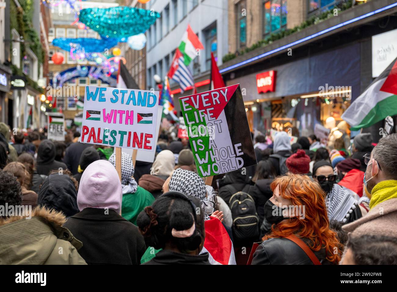 London / UK  23 DEC 2023. Hundreds of people demonstrated in Carnaby street in London, calling for an immediate ceasefire in Gaza and a boycott of “Israel-linked” brands. Aubrey Fagon / Alamy Live News Stock Photo