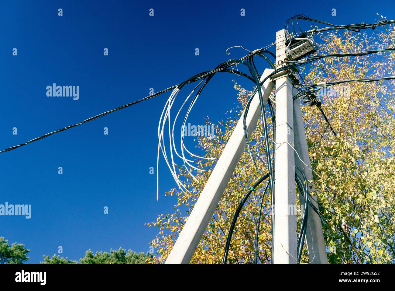 concrete pillar with numerous electrical wires and connectors, serving as an essential component of urban infrastructure and enabling power supply acr Stock Photo