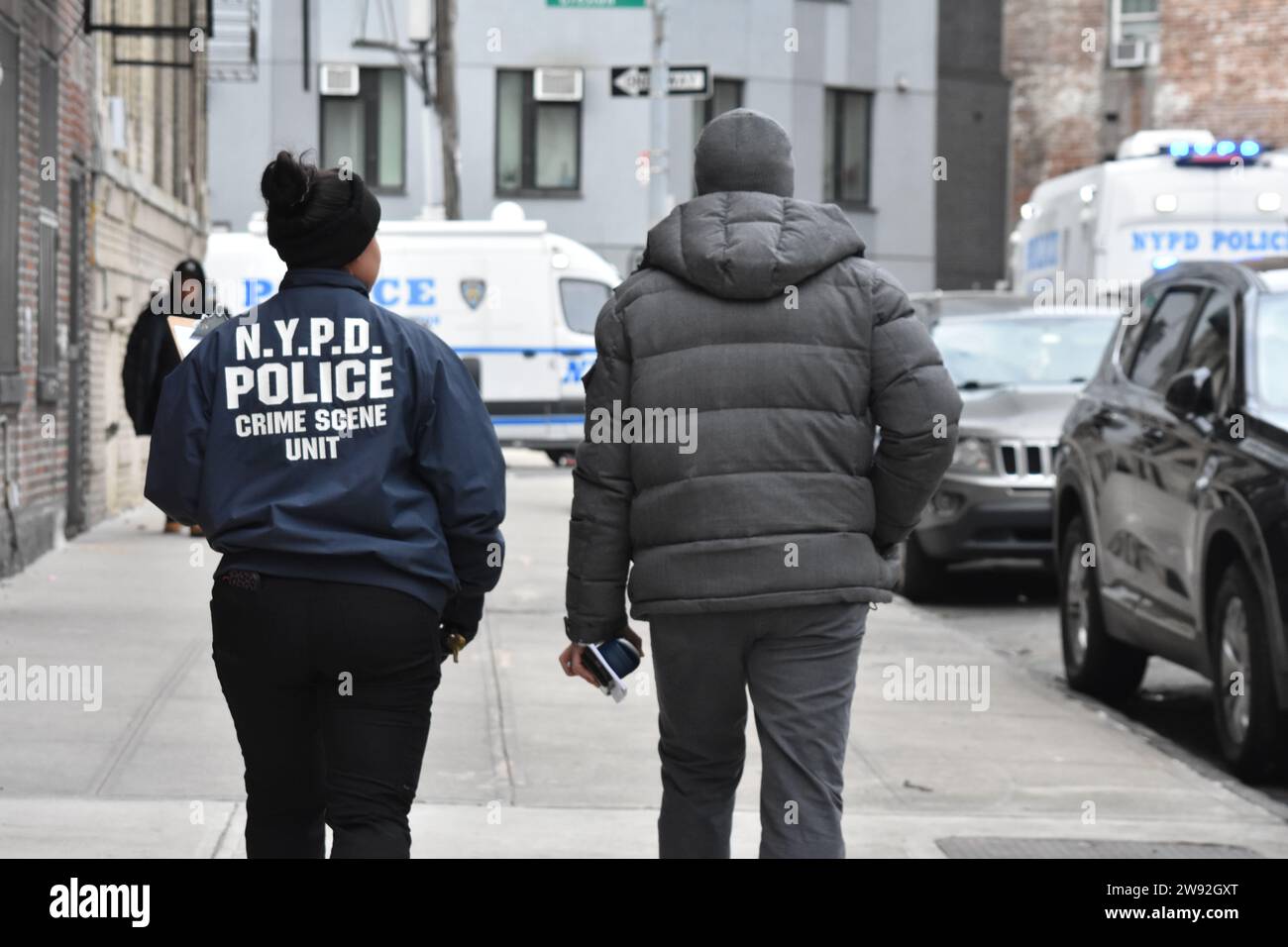 NYPD officers at the crime scene. Authorities were seen gathering evidence and working at the scene of a police involved shooting in the Bronx, Saturday afternoon in the area of Creston Avenue and Minerva Place. Two officers responded to 2865 Creston Avenue, 13th Floor, Apartment G and were met by a 19-year-old female with slice wounds to her facial area. Suspect was holding his mother in a headlock with a knife and officers fatally shot the suspect after he refused to drop the weapon. (Photo by Kyle Mazza/SOPA Images/Sipa USA) Stock Photo