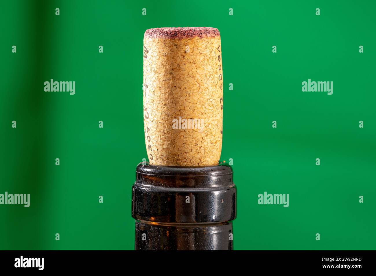 detail of a cork stopper used in a bottle of red wine with a ruby mark absorbed on the contact surface Stock Photo