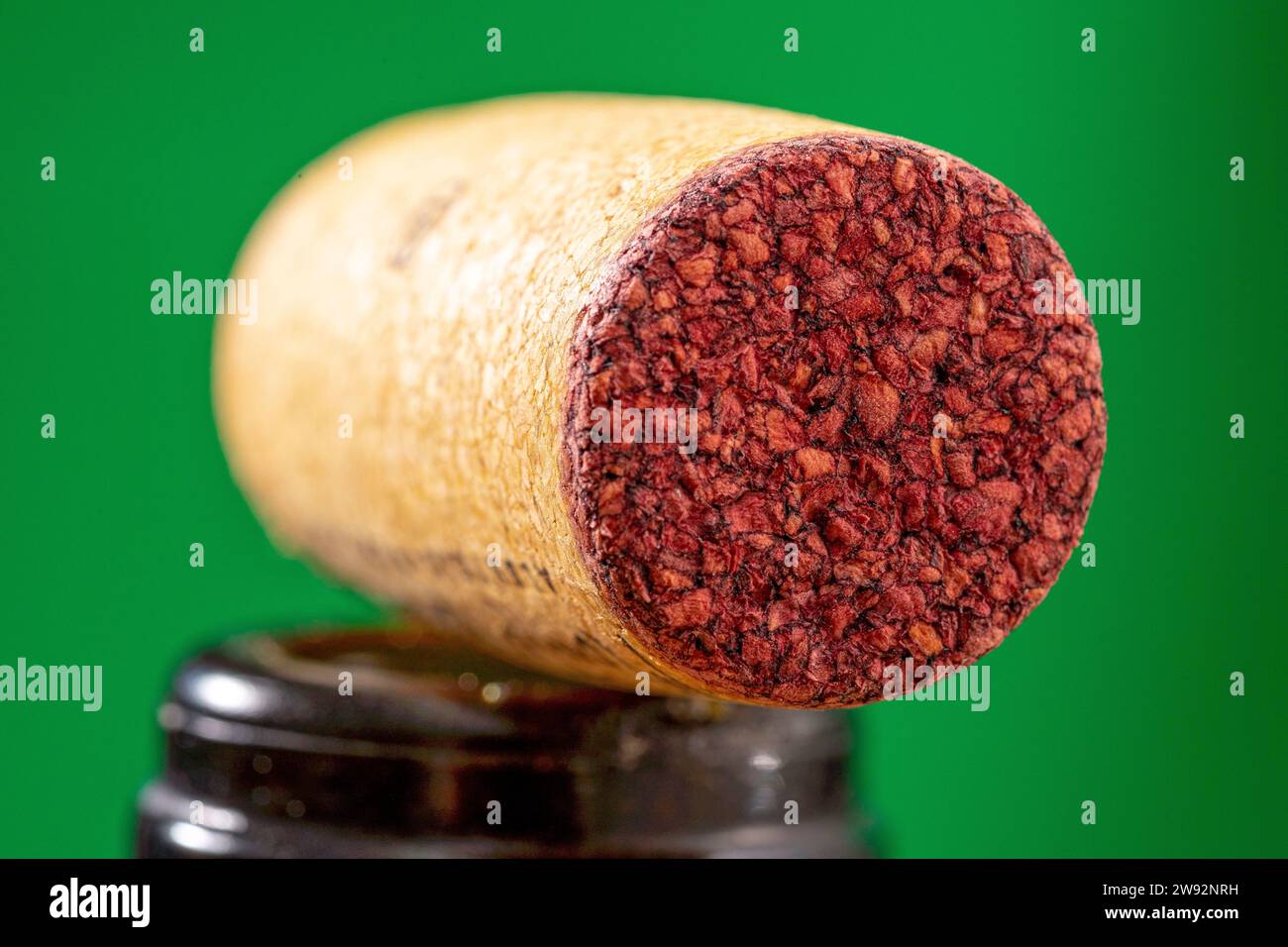 detail of a cork stopper used in a bottle of red wine with a ruby mark absorbed on the contact surface Stock Photo
