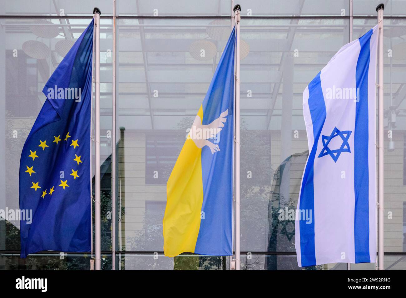 Münster, NRW, Germany. 23rd Dec, 2023. Three flags fly outside the Münster District Authority regional government offices (left to right) a EU flag, a Ukraine Peace flag (with a white dove) and the flag of Israel, in solidarity with both countries and as a symbol of peace. Credit: Imageplotter/Alamy Live News Stock Photo