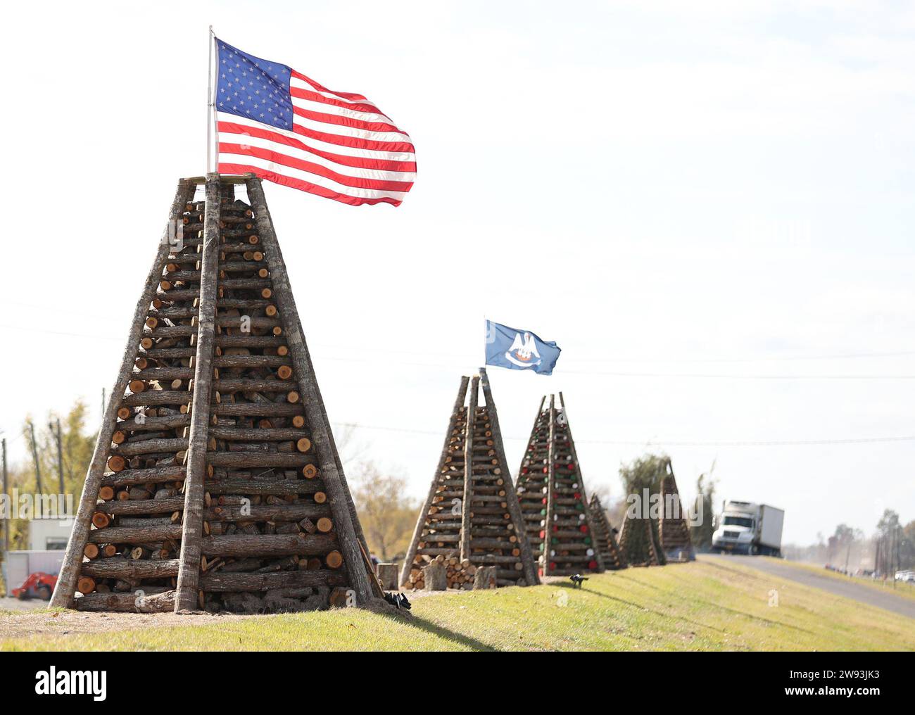 Reserve, USA. 23rd Dec, 2023. A group of bonfires line up the levee on