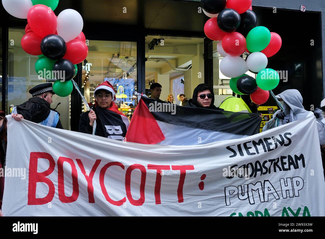 London, UK. 23rd December, 2023. Feminist activist group Sisters Uncut organised a protest in the central shopping areas of Oxford Street and Regent Street, supporting a full ceasefire in Gaza and the boycott of Israeli linked - or owned businesses. Credit: Eleventh Hour Photography/Alamy Live News Stock Photo
