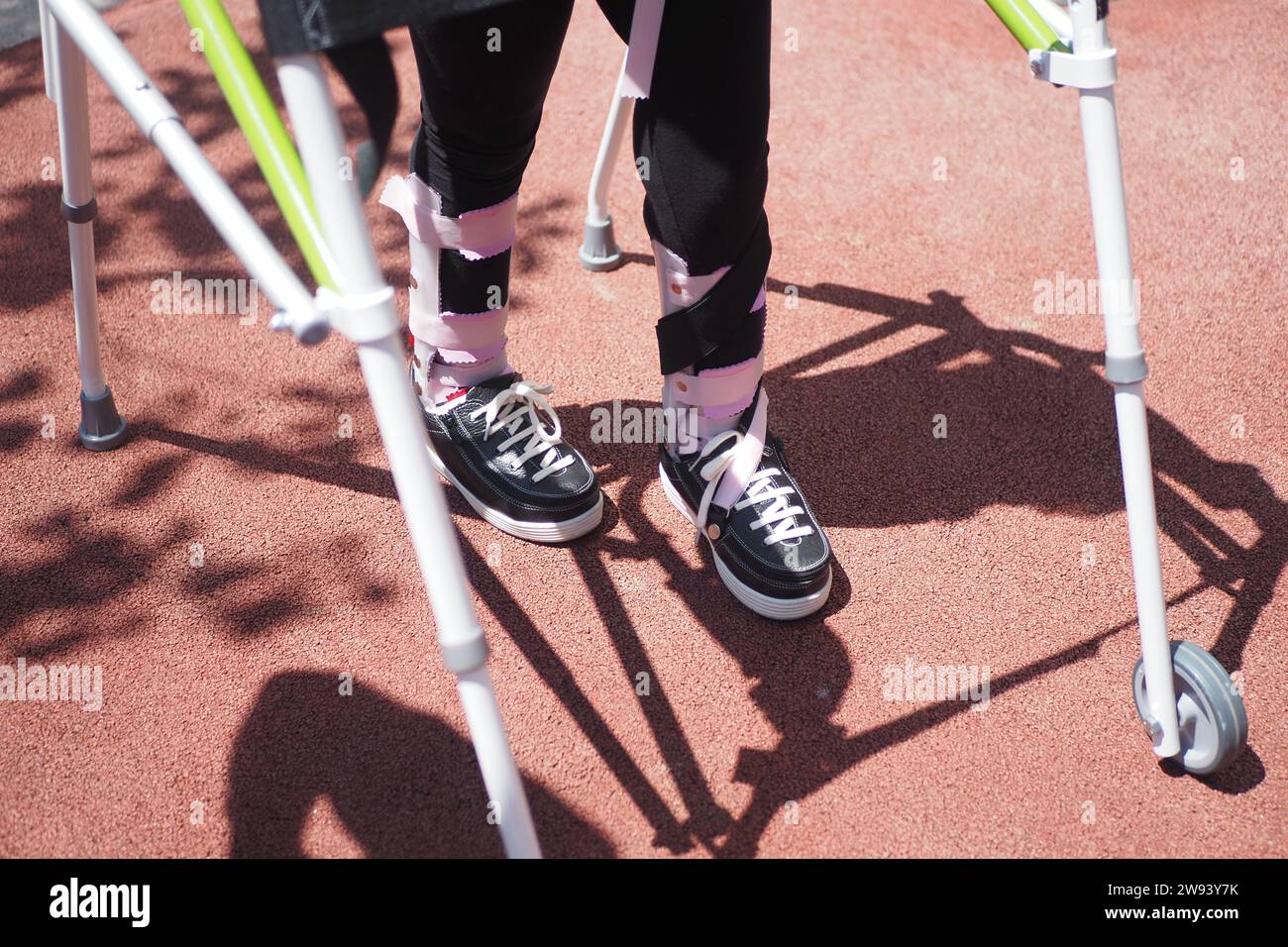 child with walking frame and knee orthosis outdoor Stock Photo Alamy